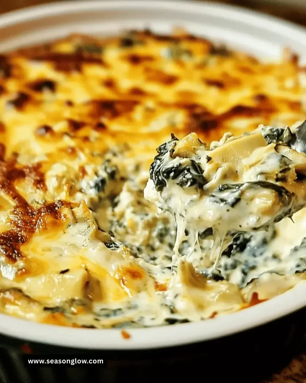 Bowl of creamy spinach artichoke dip served with tortilla chips
