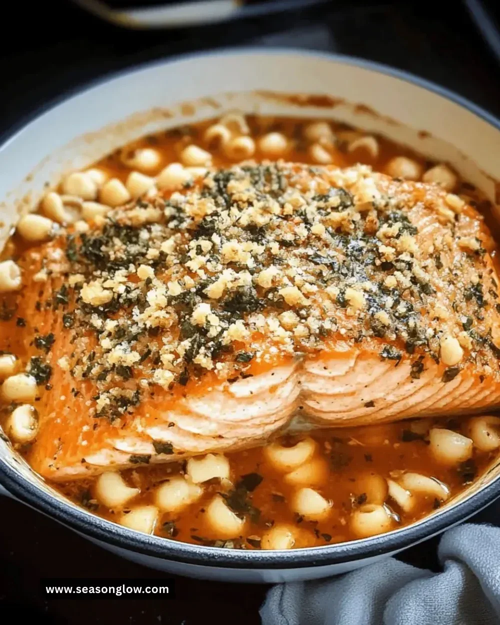 Delicious herb-crusted salmon fillet garnished with fresh herbs and lemon slices.