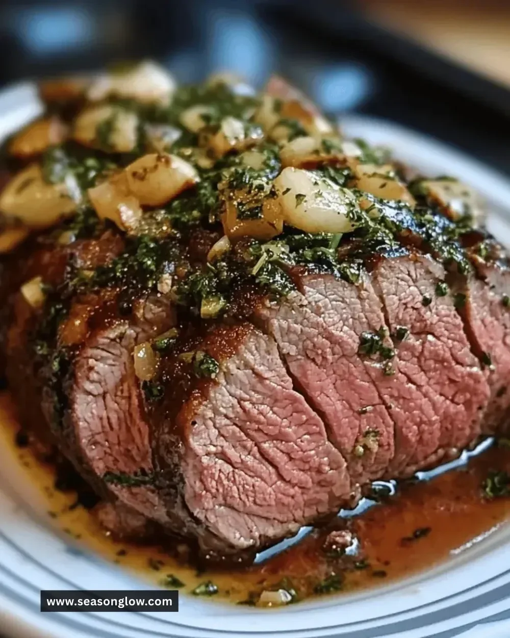 Best Tender Herb Butter Roast served with fresh herbs and garlic