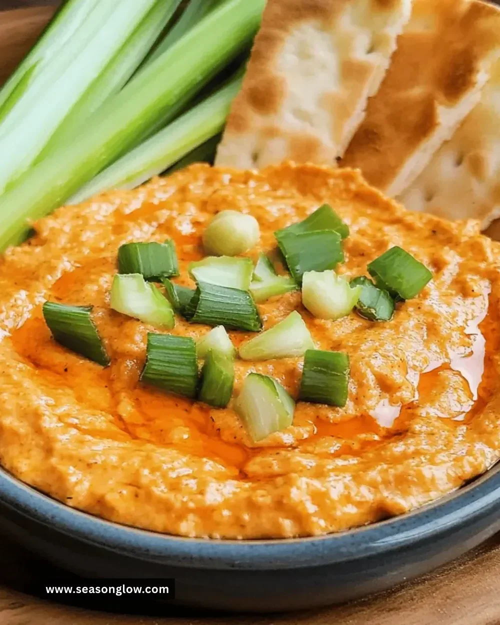 Delicious zesty Buffalo Chickpea Dip served in a bowl with fresh vegetables