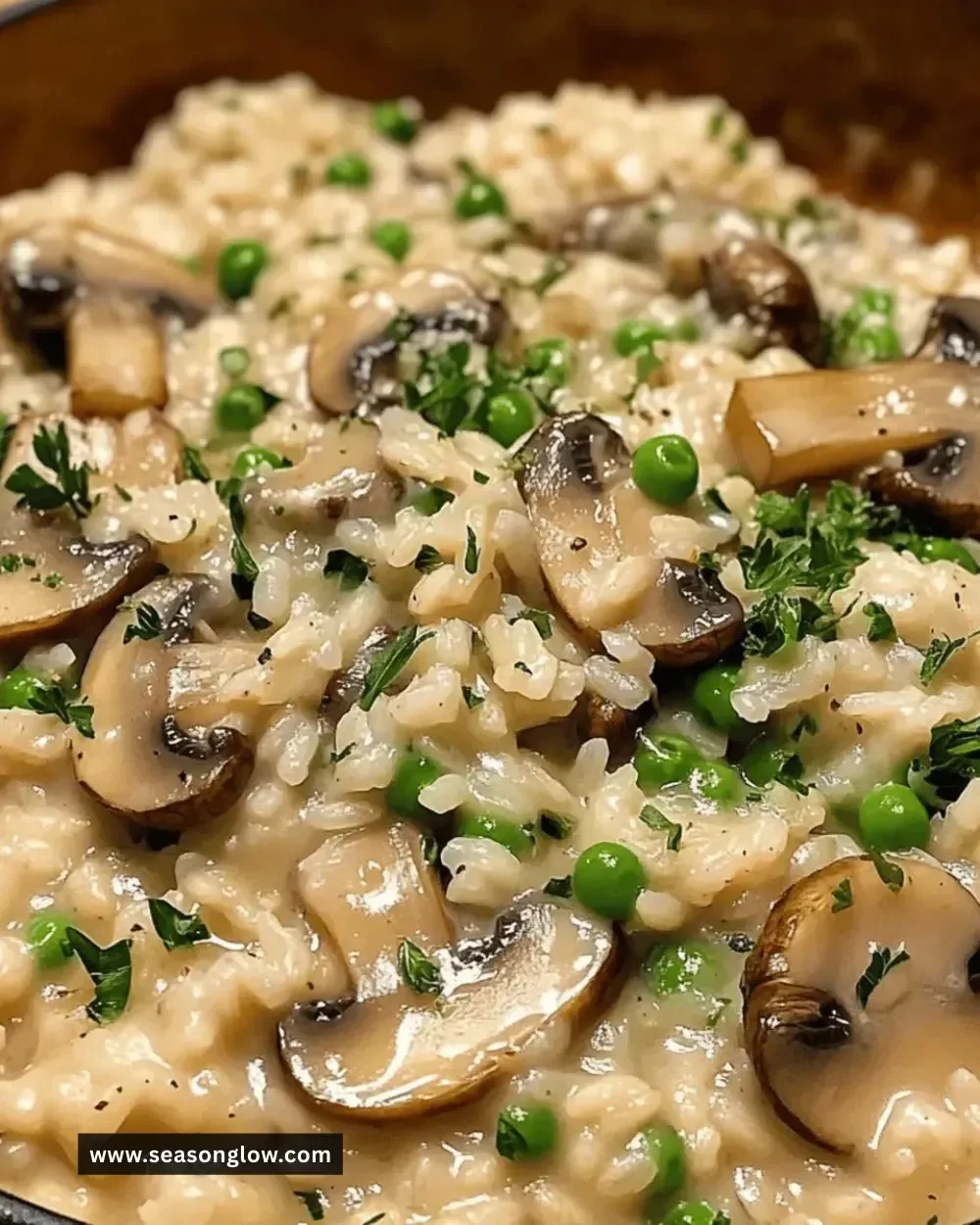 Creamy mushroom vegetarian risotto garnished with fresh herbs on a white plate.