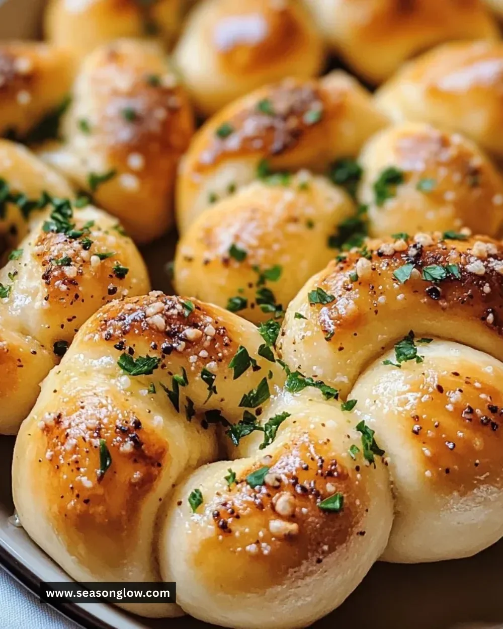 Easy and delicious homemade garlic knots with herbs and buttery glaze