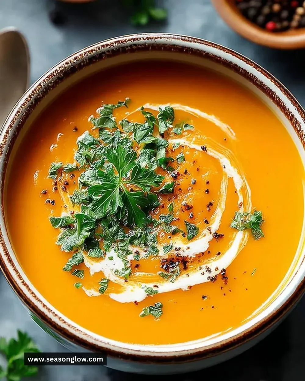 Bowl of easy butternut squash sweet potato soup topped with herbs.