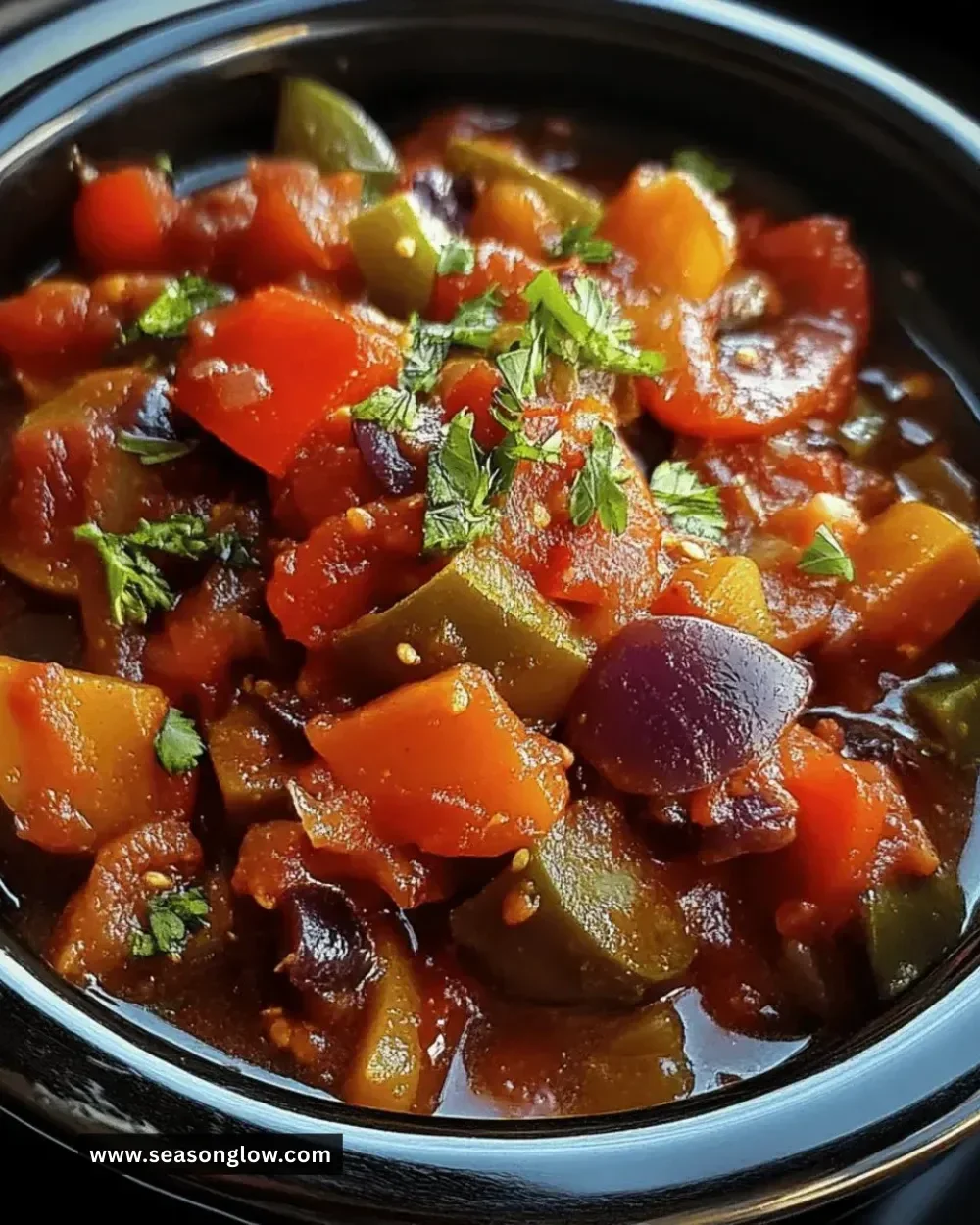 Bowl of easy crockpot ratatouille with colorful vegetables and herbs