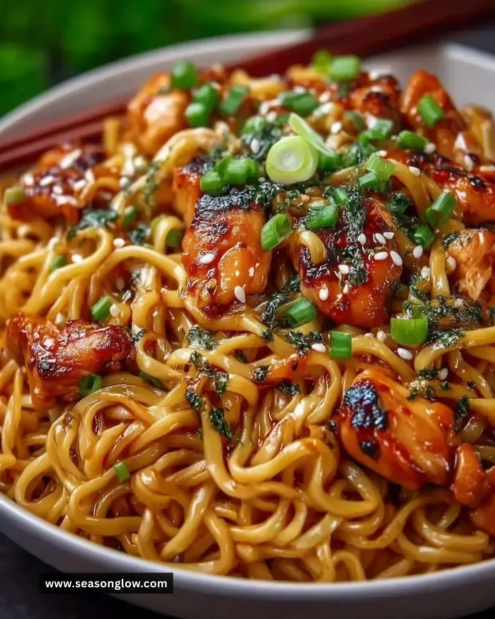 Delicious easy garlic chicken noodles served in a bowl with herbs