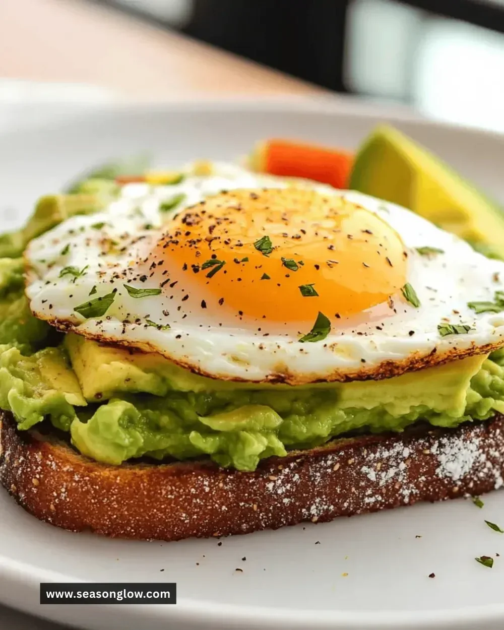 Healthy avocado toast topped with a poached egg on whole grain bread