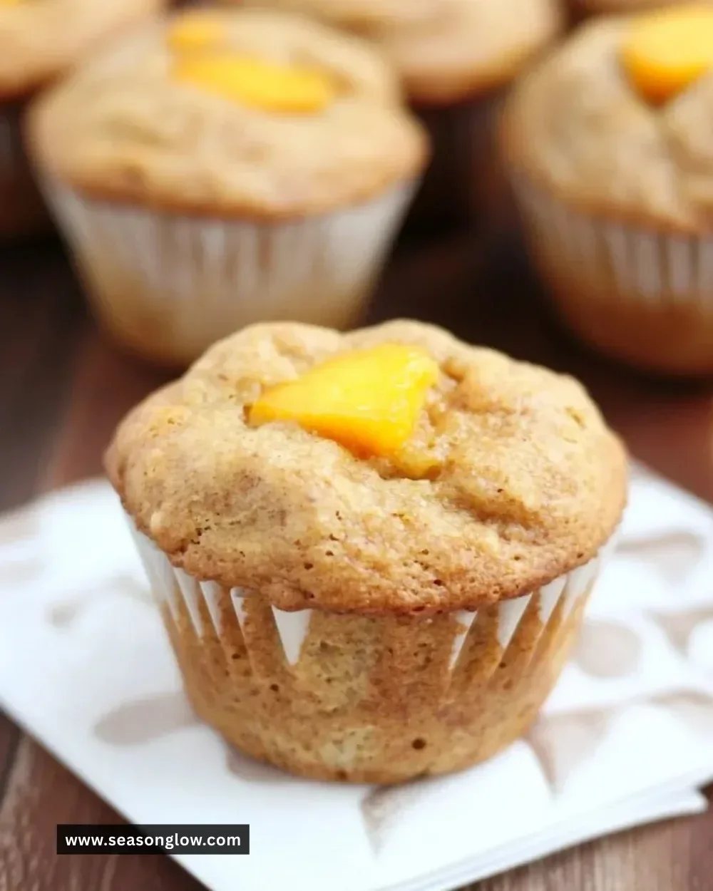 Healthy honey peach muffins fresh out of the oven with peaches and honey