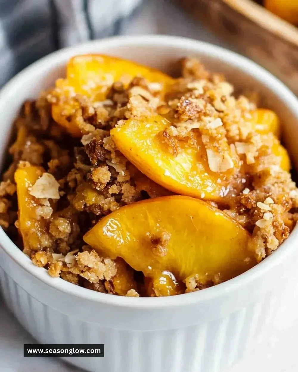 Delicious Healthy Peach Crumble served in a bowl with a scoop of yogurt