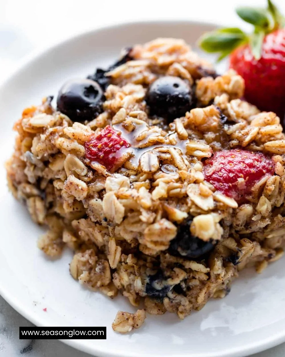 Bowl of baked oatmeal topped with fruits and nuts for a healthy breakfast