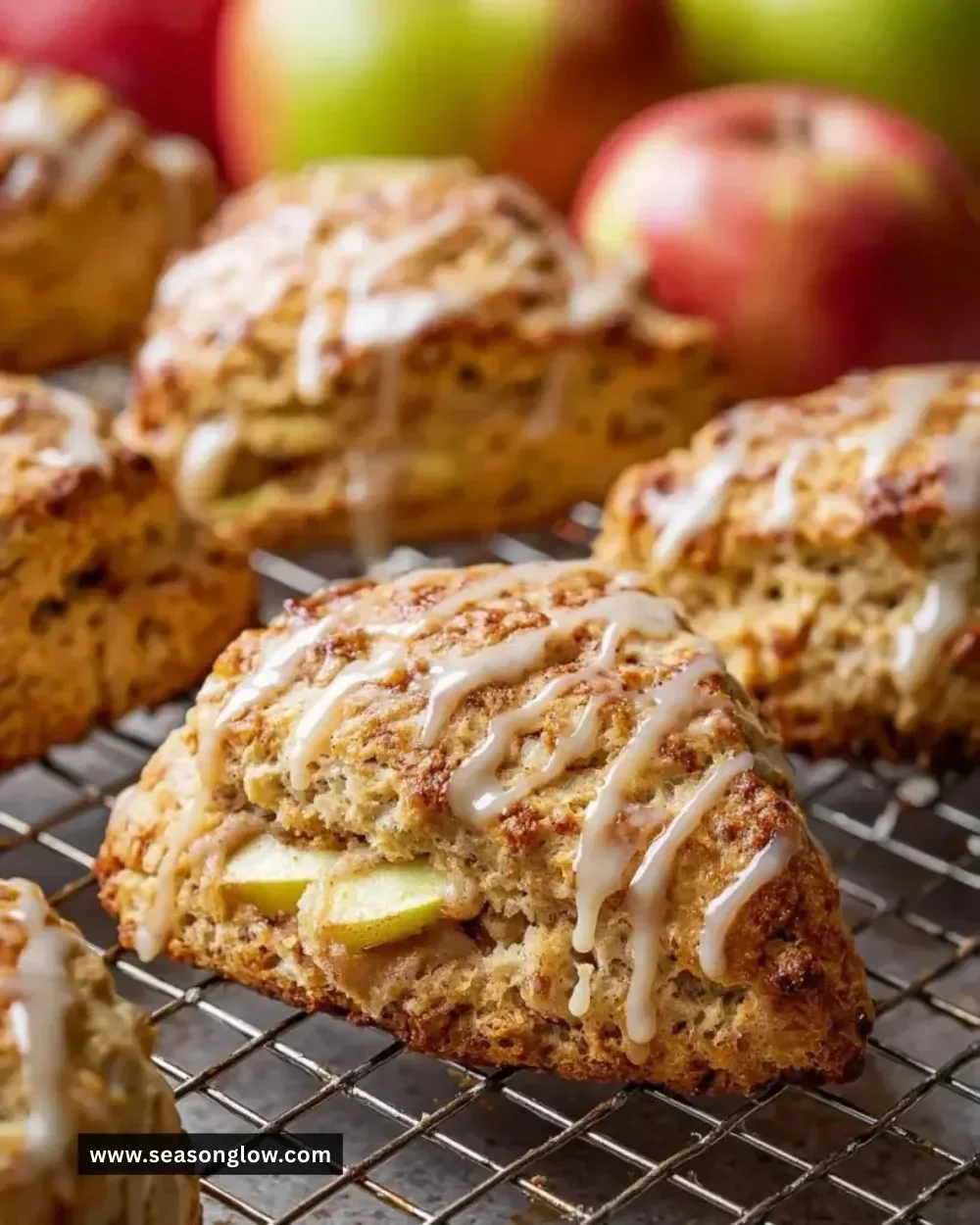 Freshly baked apple scones drizzled with maple glaze on a wooden table