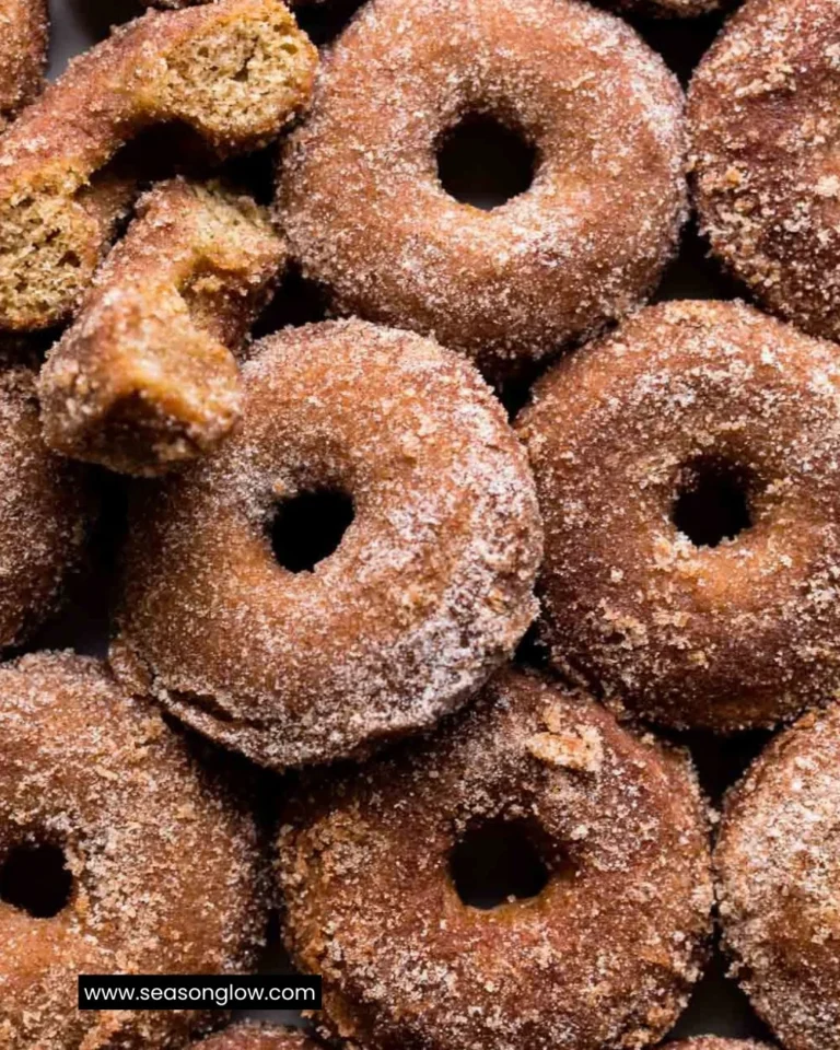 Freshly baked apple cider donuts topped with cinnamon sugar and served warm.