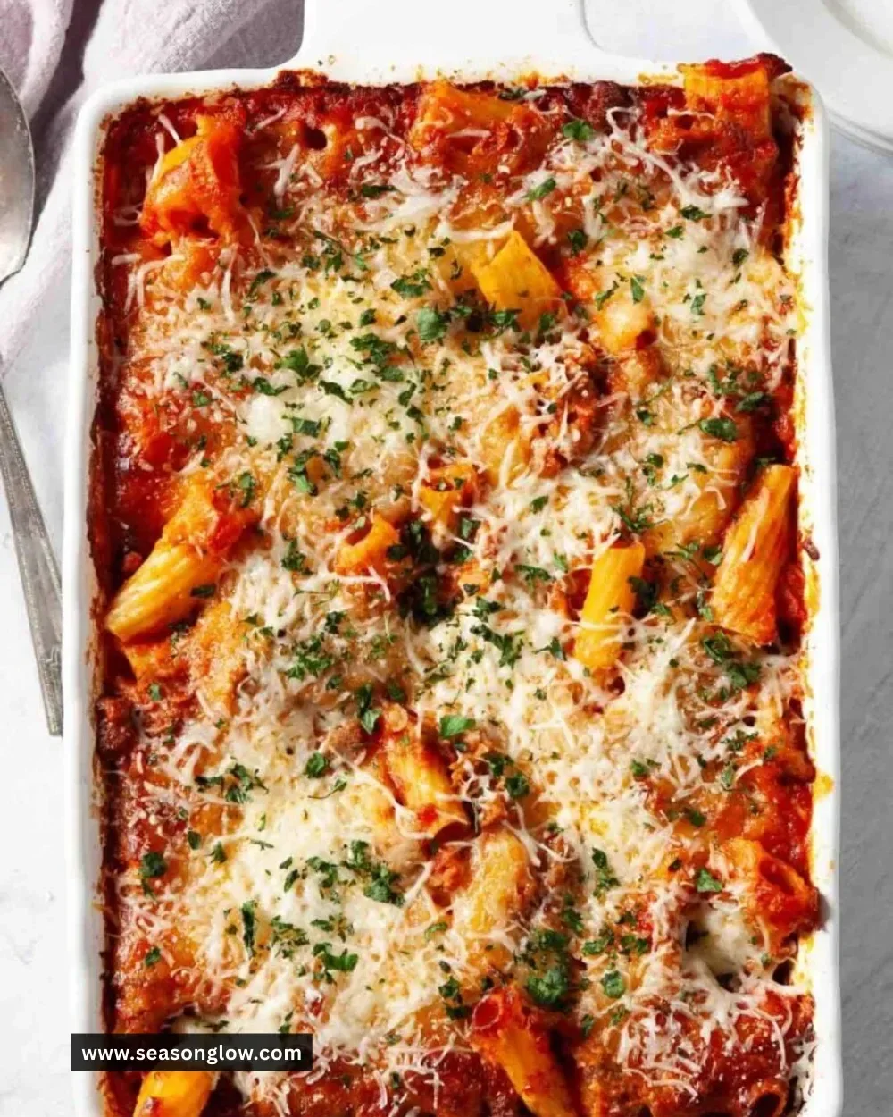 Delicious baked rigatoni with cheese and marinara sauce in a baking dish