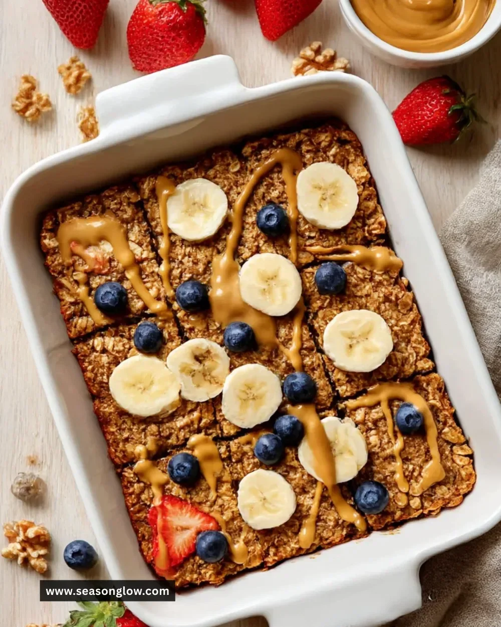 Delicious banana baked oatmeal served in a bowl with fresh bananas and nuts