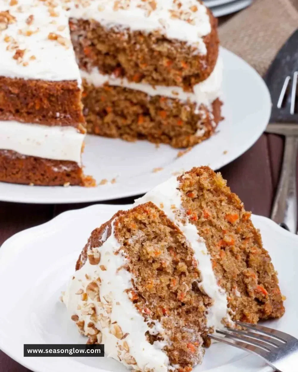 Delicious carrot cake with luscious cream cheese frosting on a rustic wooden table