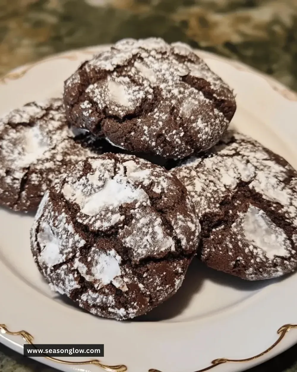 Homemade holiday chocolate crinkle cookies dusted with powdered sugar.