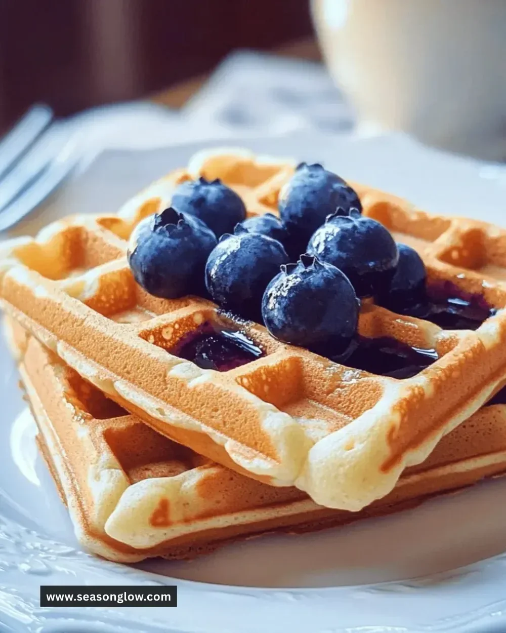 Delicious whole grain blueberry waffles topped with fresh blueberries and syrup