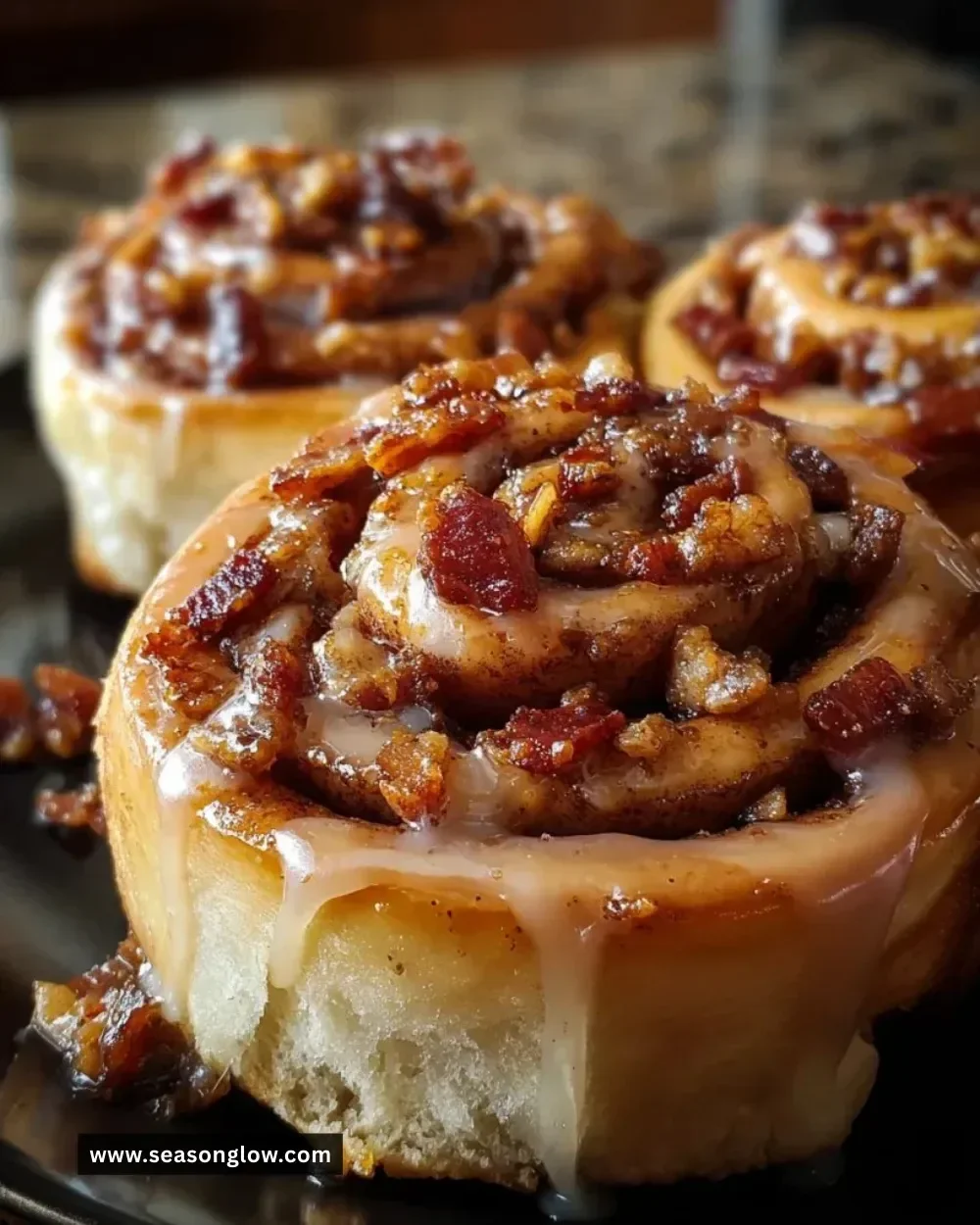 Delicious Bourbon Maple Bacon Cinnamon Rolls topped with a rich glaze