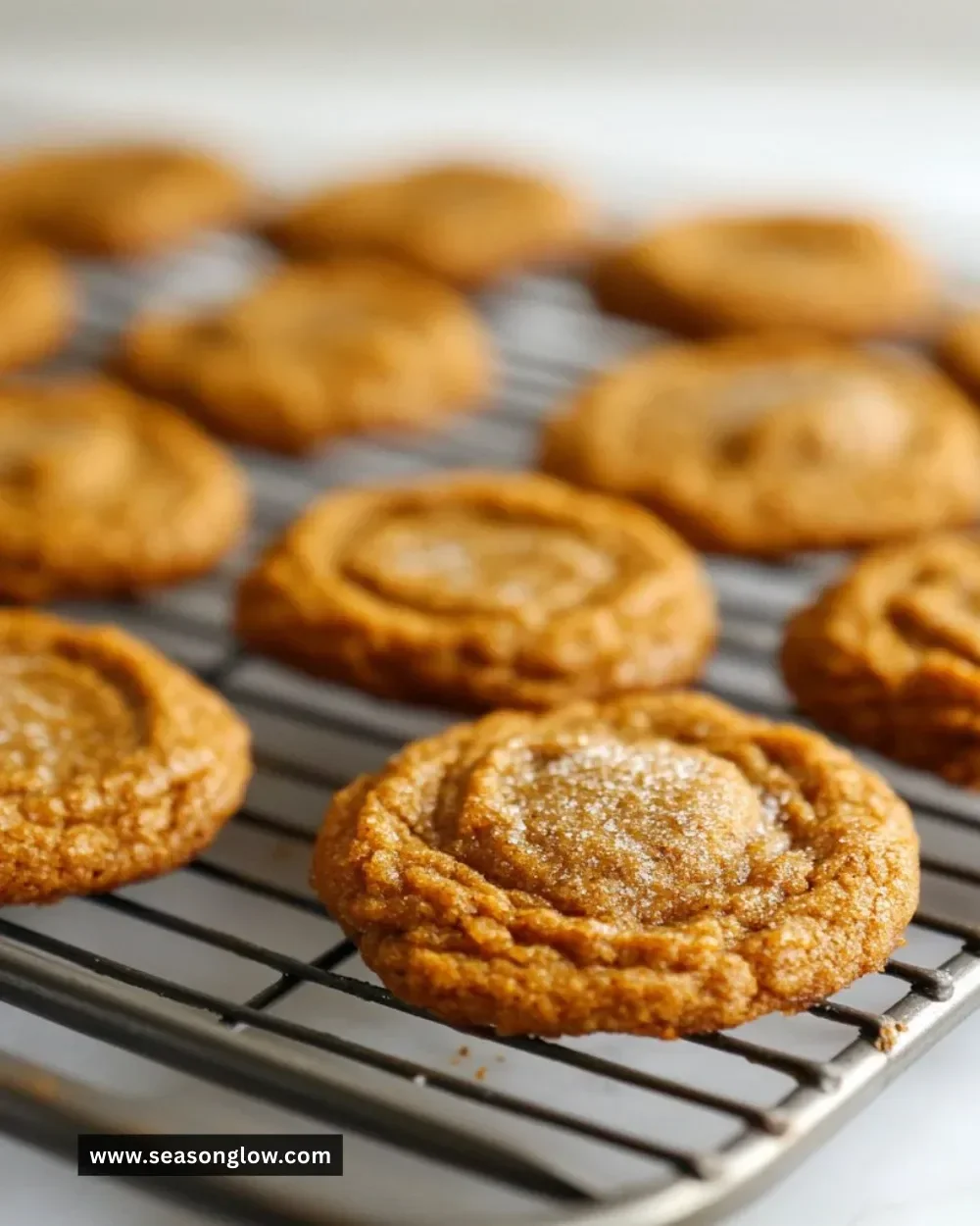 Delicious brown butter and maple chewy pumpkin cookies on a baking tray.