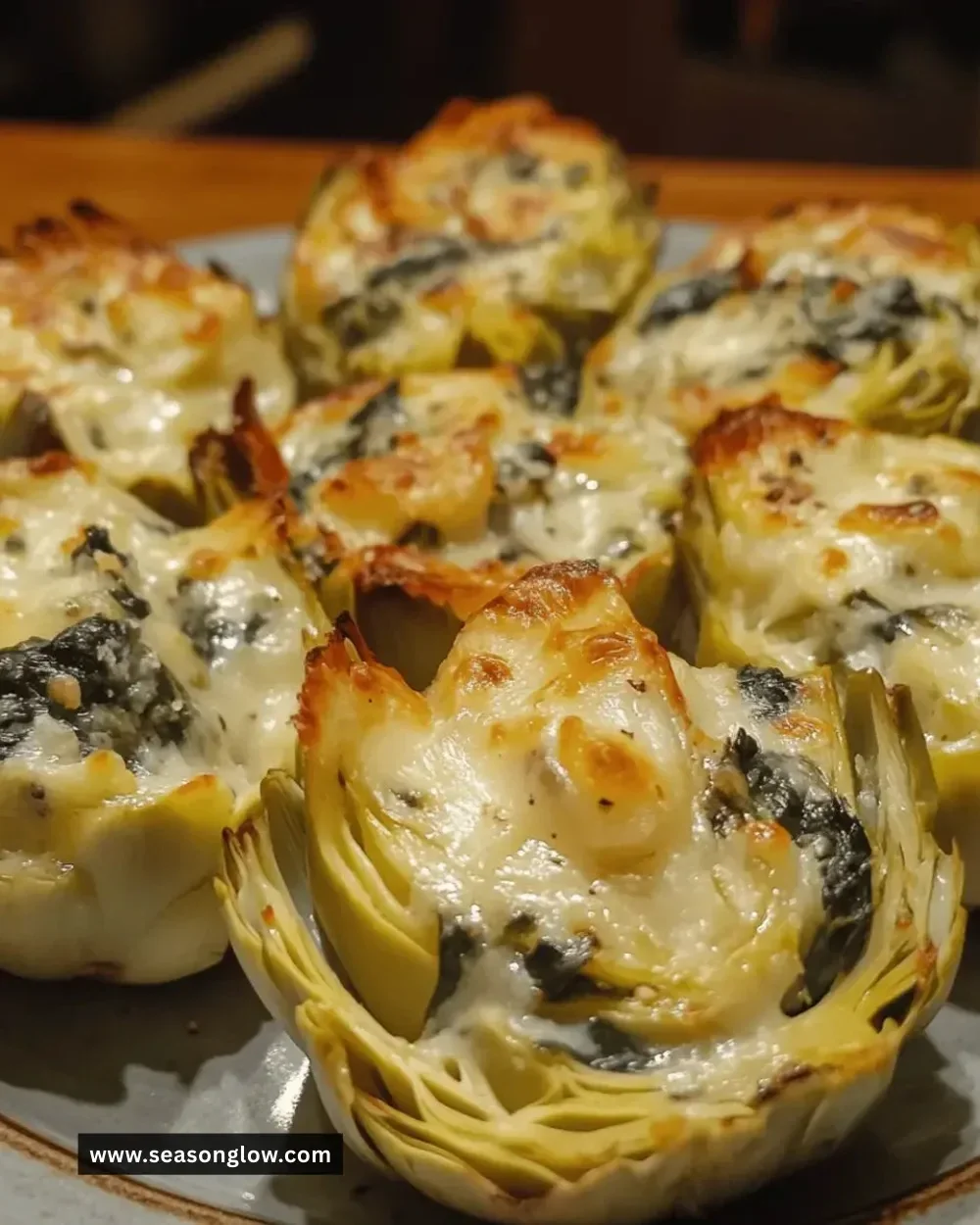Cheesy spinach artichoke cups served on a platter, perfect for appetizers.