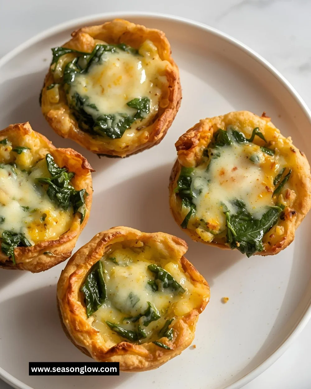 Cheesy spinach egg cups baked to perfection in muffin tins for a healthy meal.