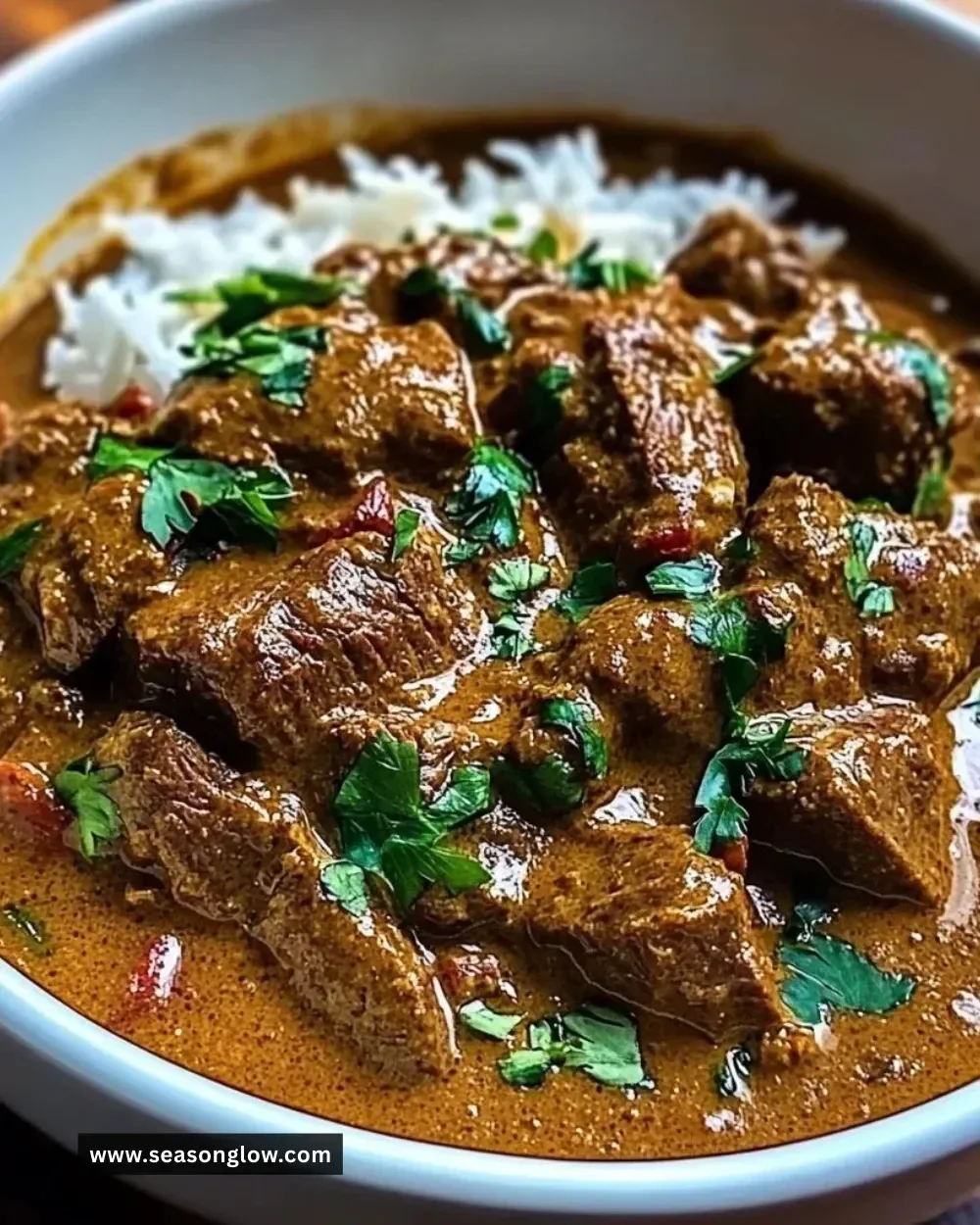 Delicious coconut-infused beef curry in a bowl with herbs