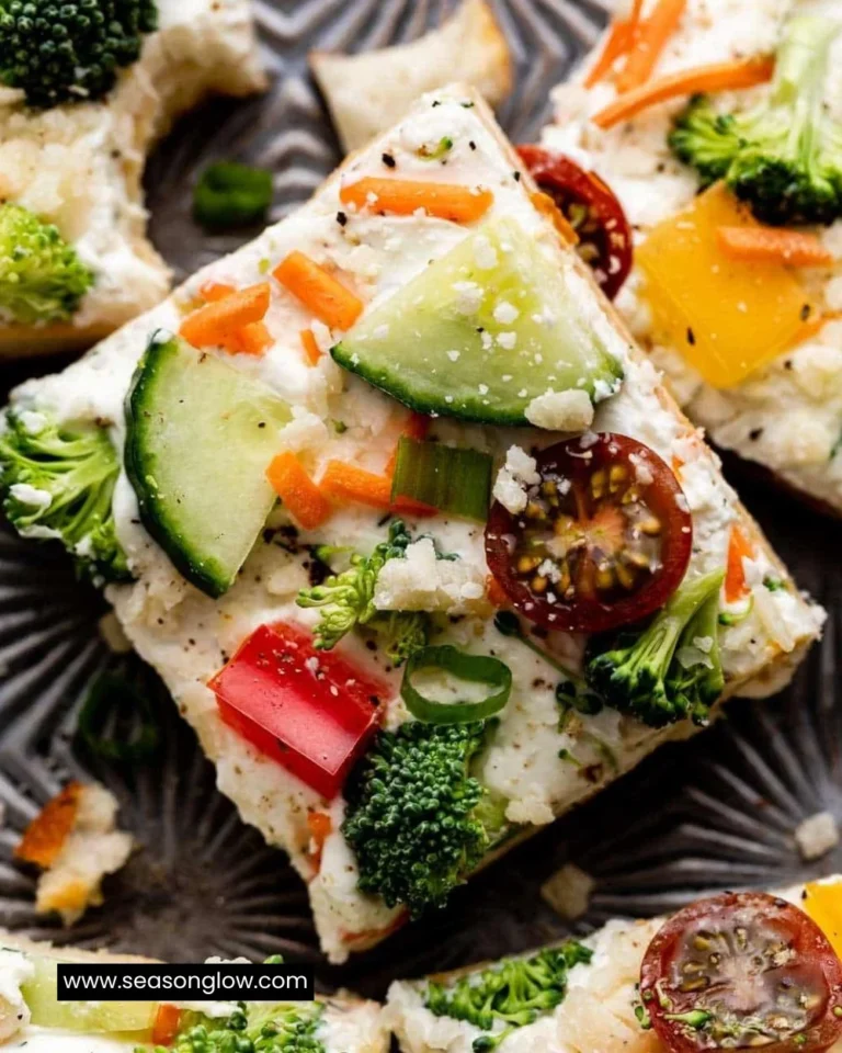Cold veggie pizza topped with fresh vegetables and herbs