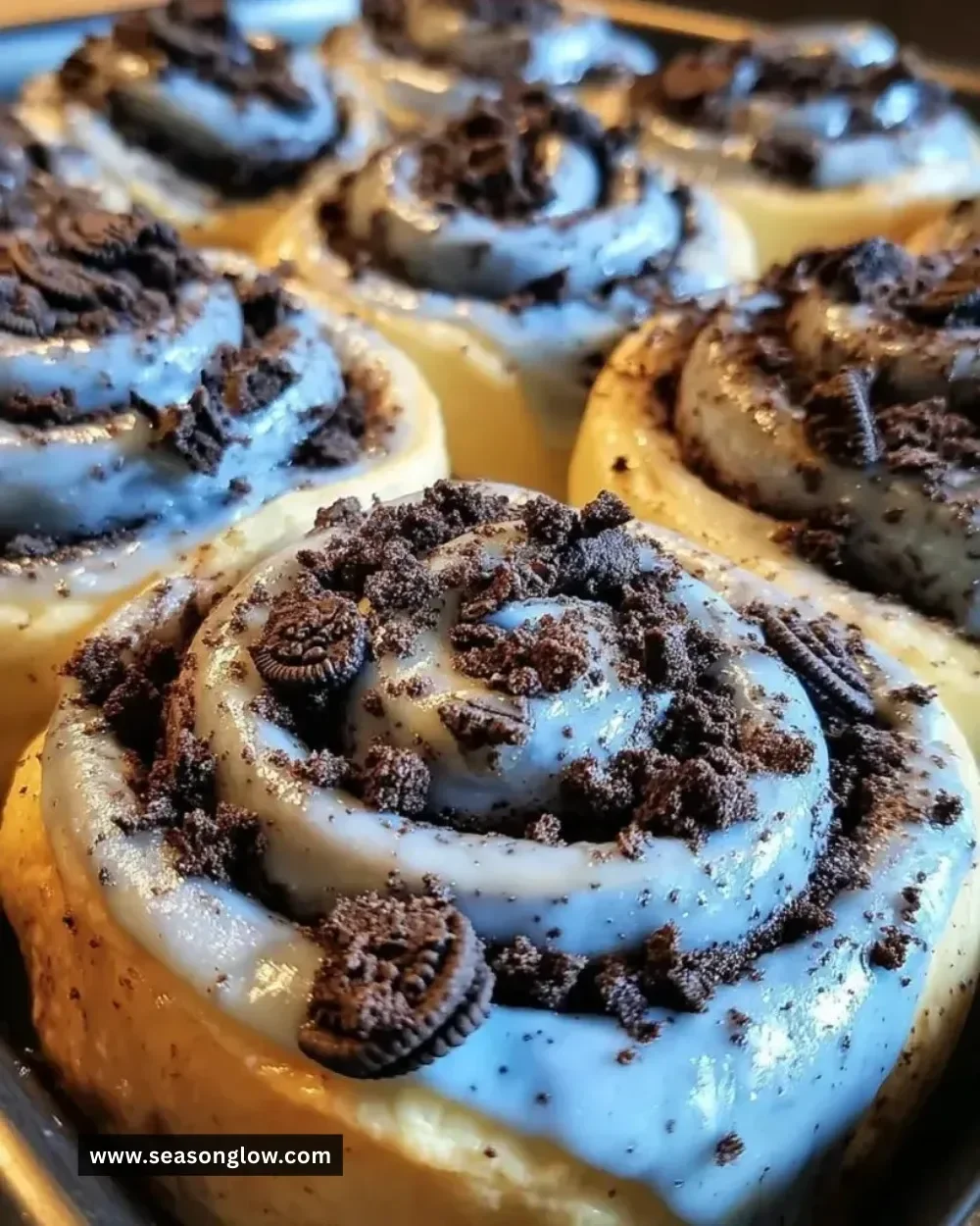 Delicious Cookie Monster Cinnamon Rolls topped with icing and cookie pieces