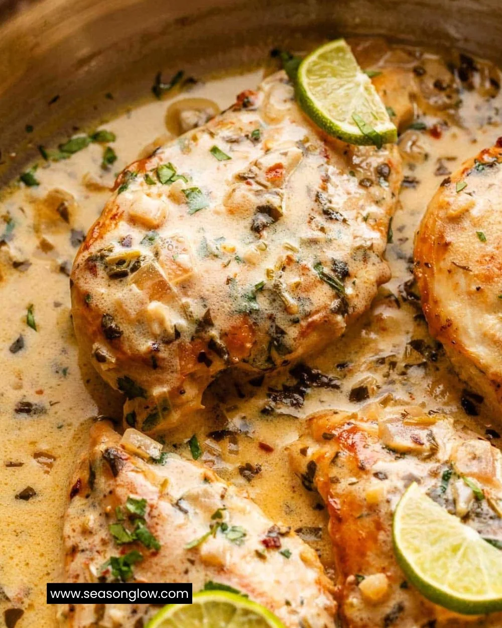 Creamy cilantro lime chicken dish garnished with fresh cilantro and lime wedges