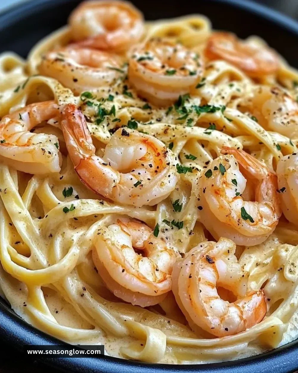 Creamy garlic shrimp Alfredo pasta served in a bowl with parsley garnish