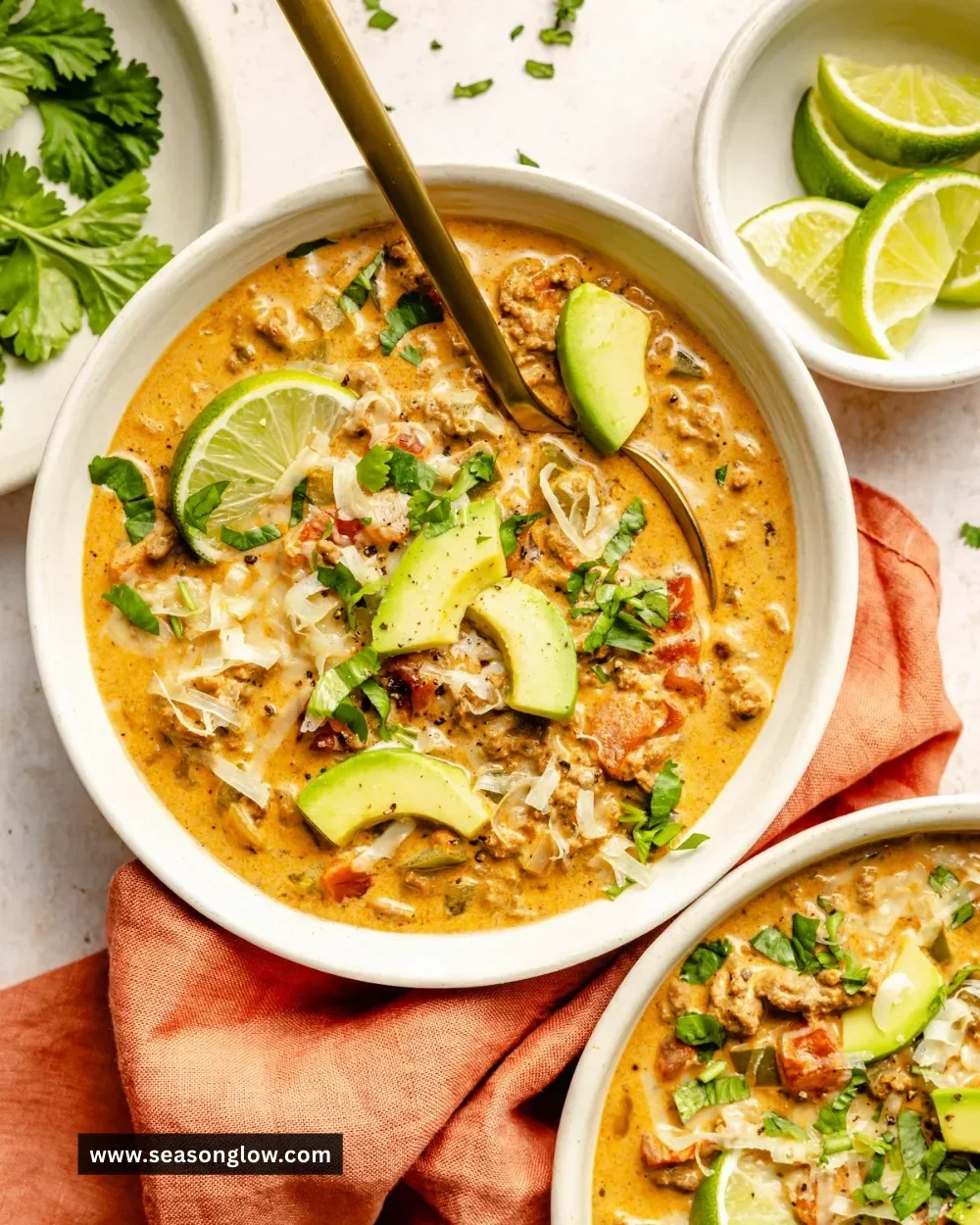 Bowl of creamy taco soup garnished with cheese and cilantro