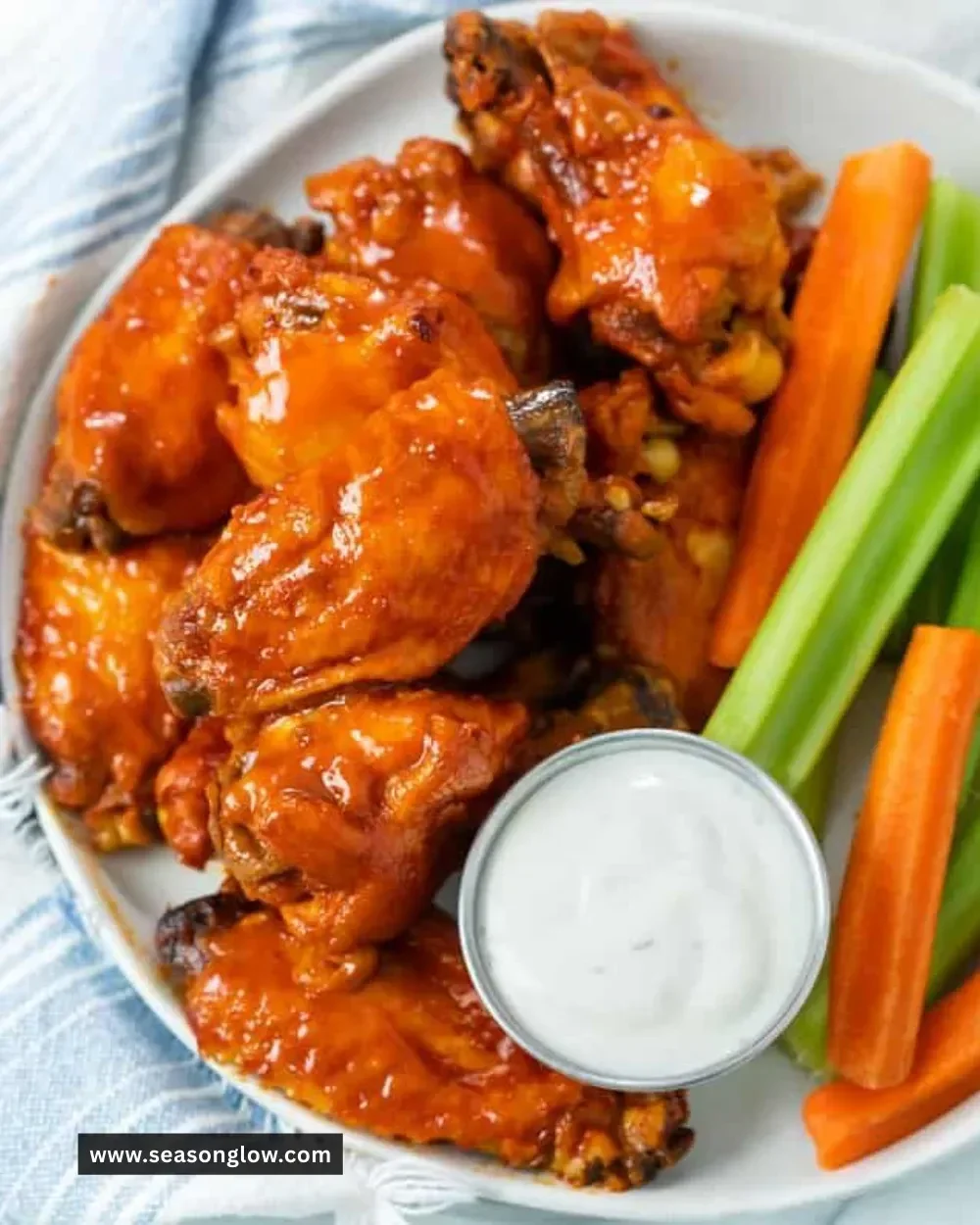 Savory Crock Pot chicken wings served with dipping sauce and vegetables.