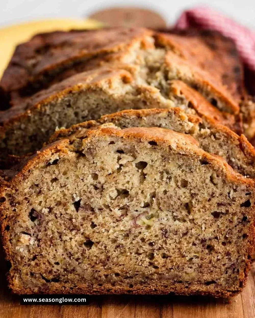 Slice of easy banana bread on a wooden table