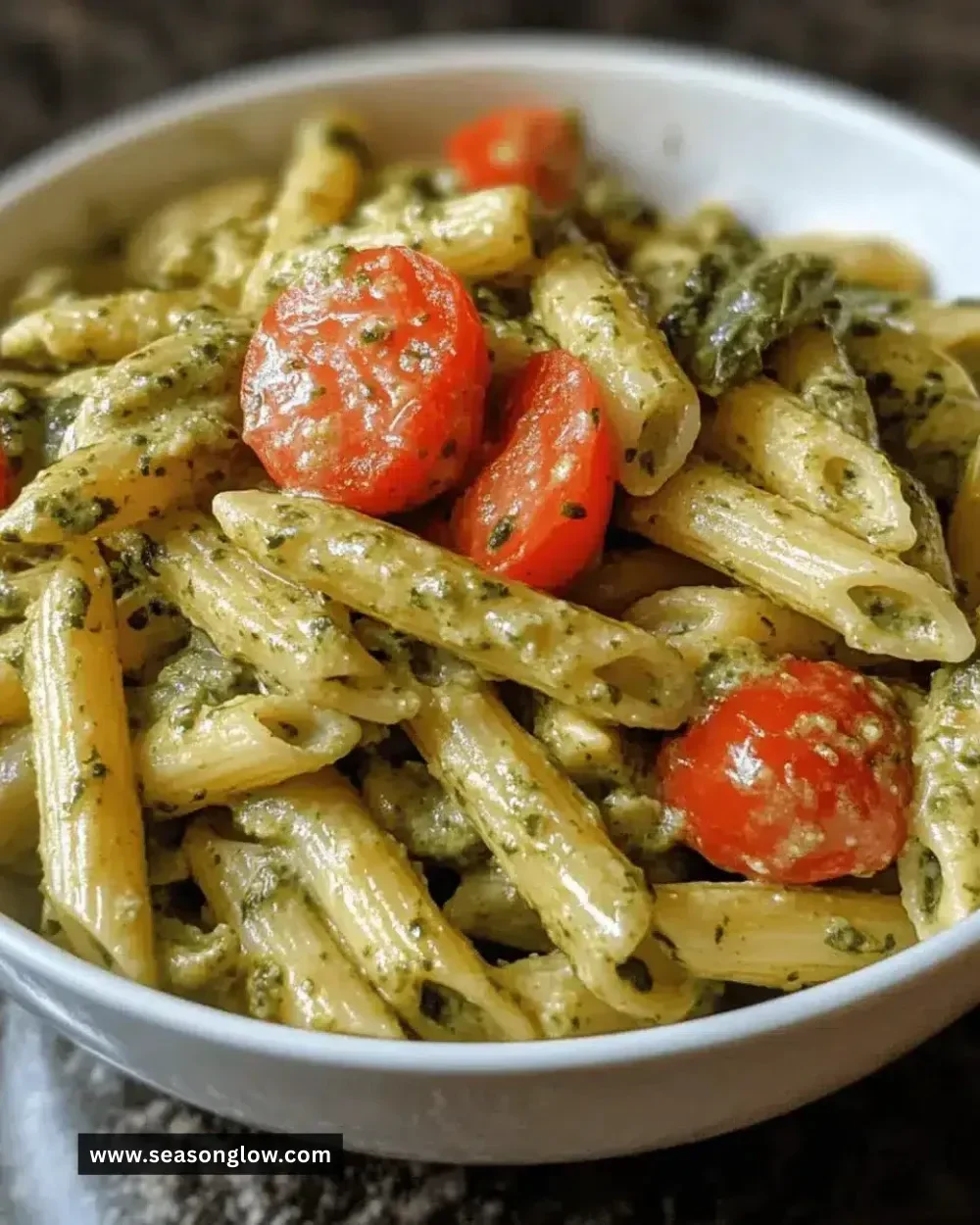 A bowl of easy creamy pesto veggie pasta served with fresh vegetables