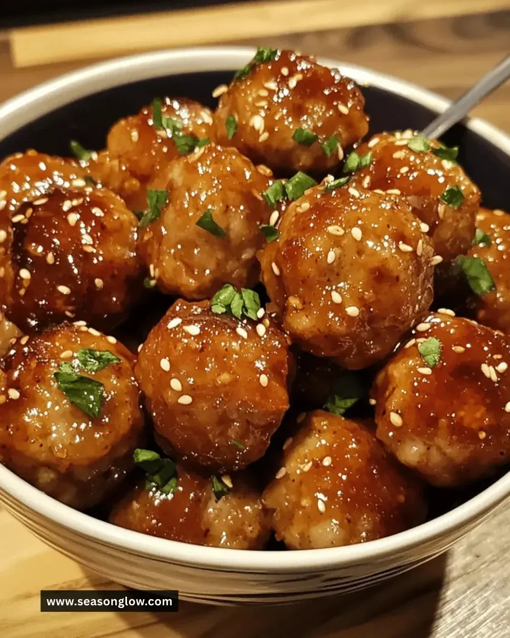 Plate of easy honey garlic chicken meatballs garnished with green onions