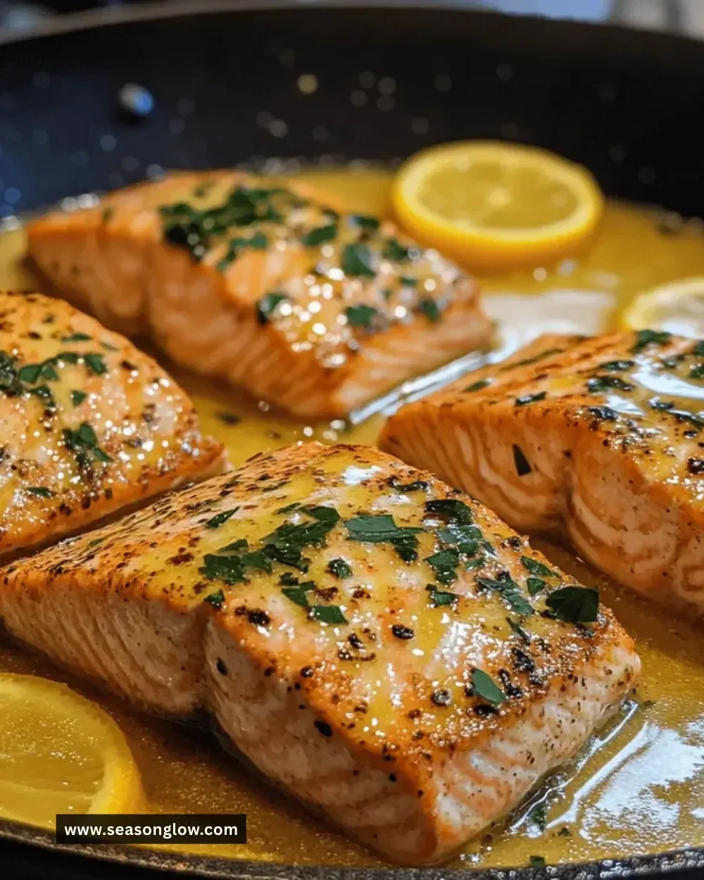 Easy lemon butter salmon skillet cooked in a pan with fresh herbs