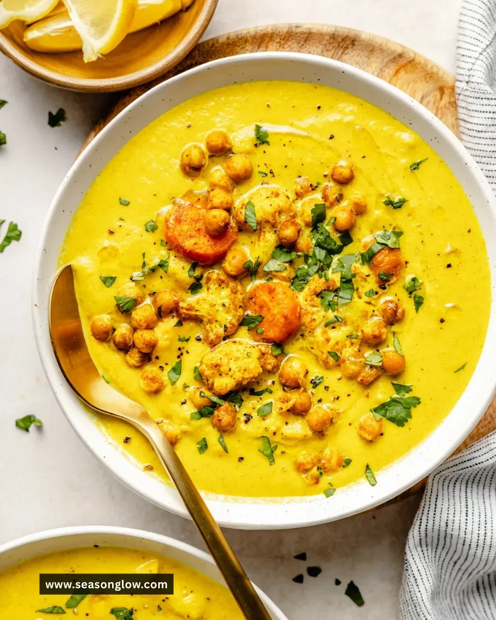 Bowl of Golden Goddess Soup filled with vibrant vegetables and spices.