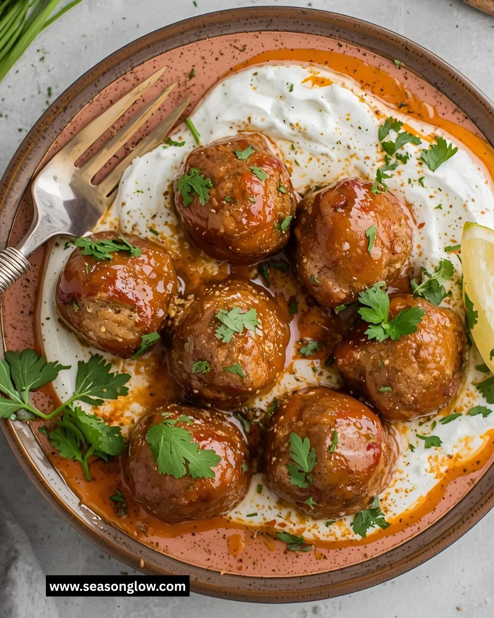 Harissa beef meatballs served with yogurt sauce and garlic