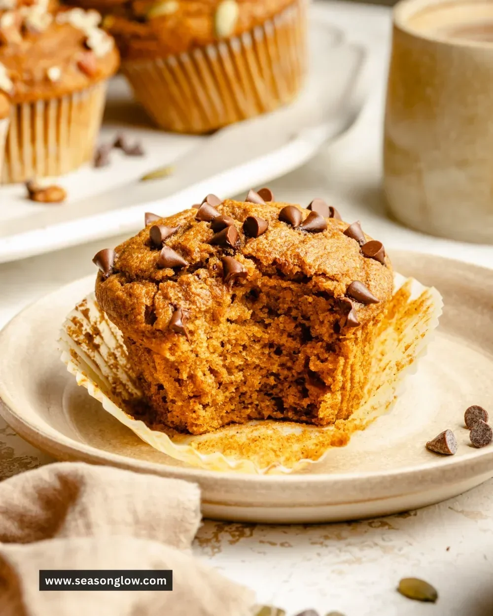 Healthy pumpkin muffins fresh out of the oven, topped with a sprinkle of spices.