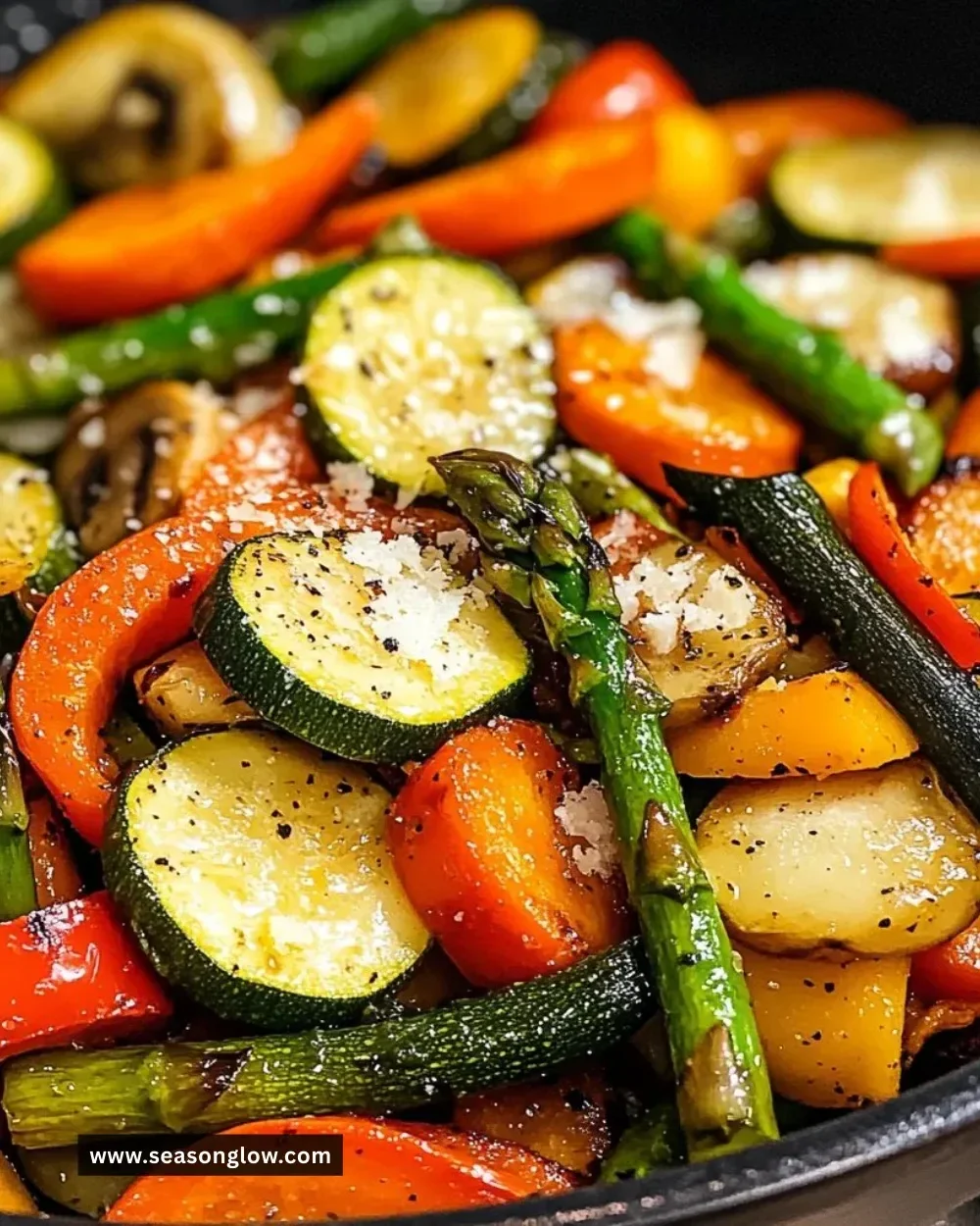 A colorful plate of healthy sautéed vegetables including bell peppers, zucchini, and carrots.