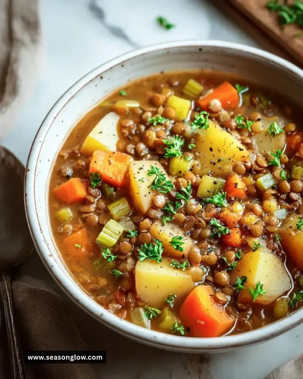 A bowl of hearty vegan stew filled with vegetables and legumes