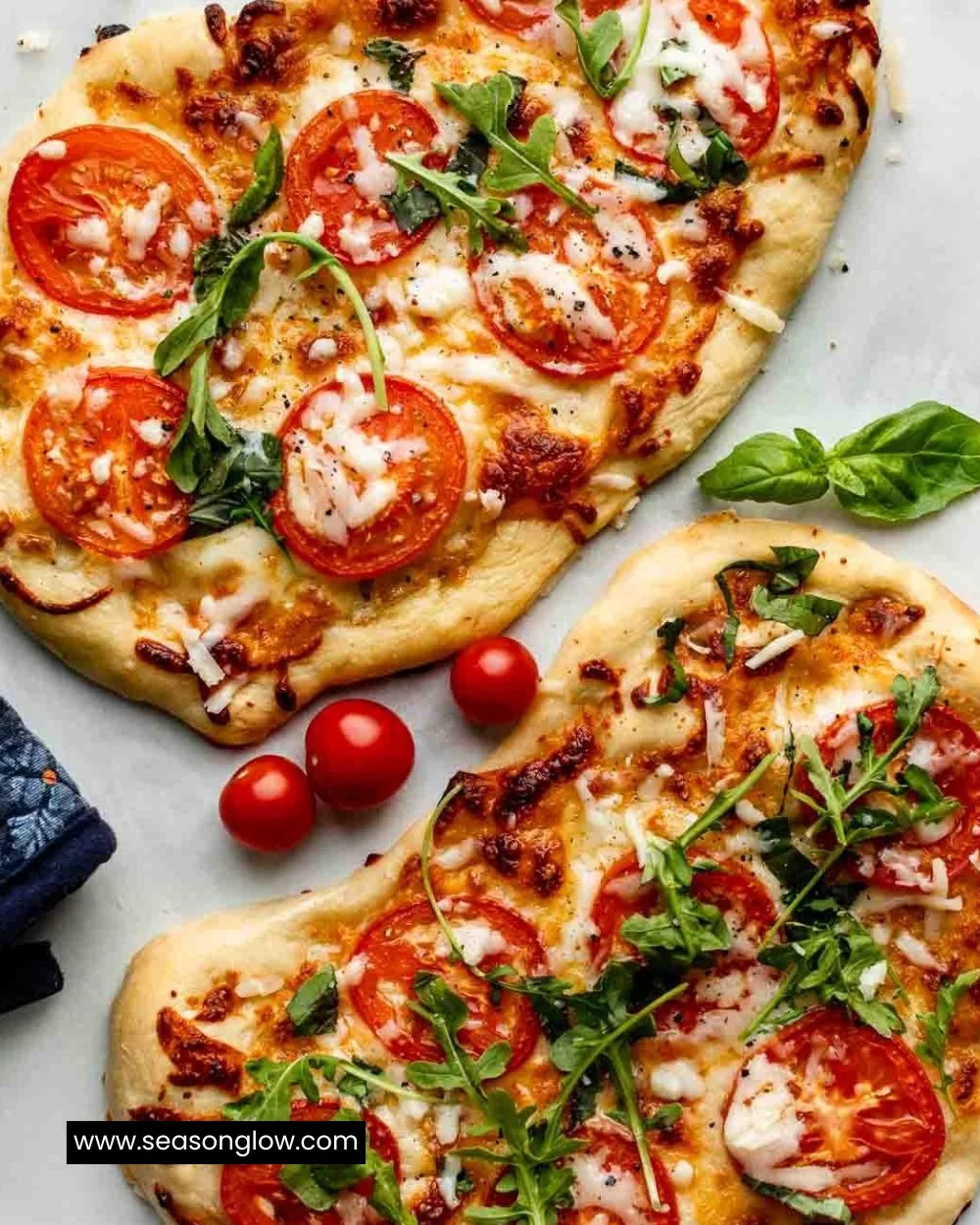 Homemade flatbread pizza topped with fresh ingredients on a wooden board.