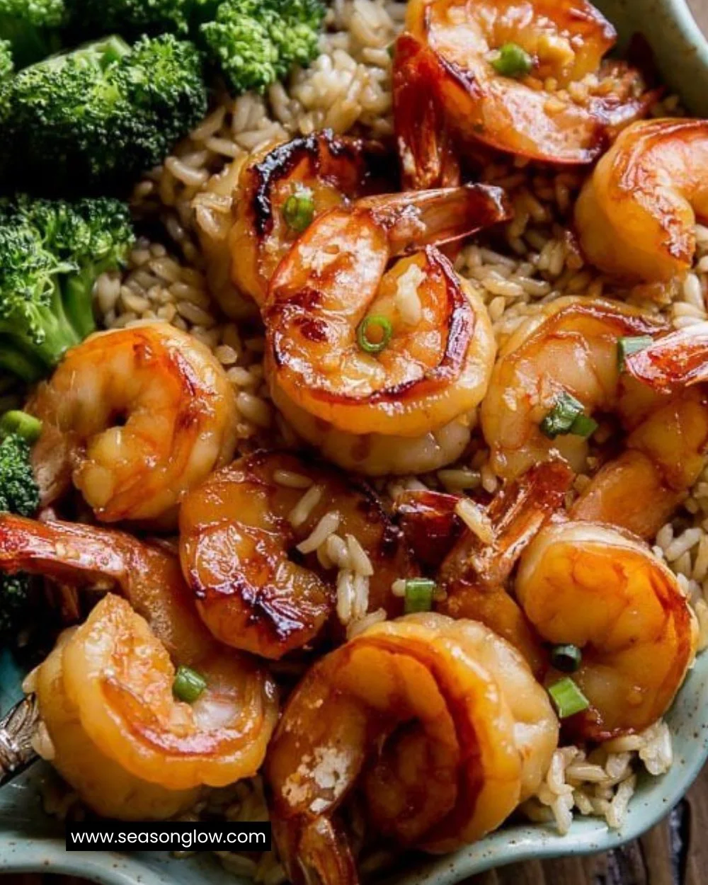 Plate of honey garlic shrimp garnished with green onions and sesame seeds