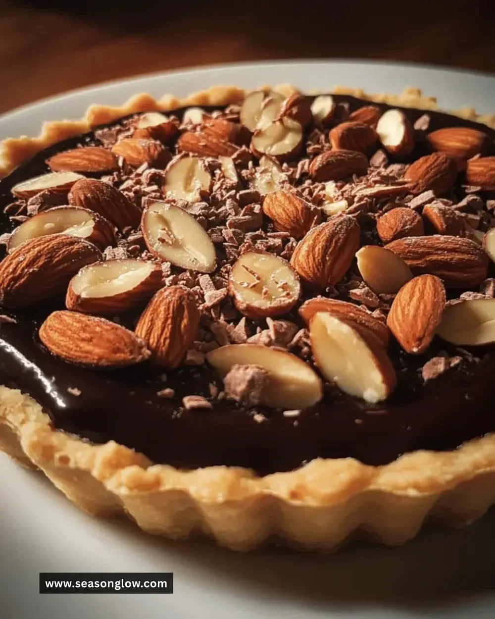 Indulgent dark chocolate almond tart with a rich chocolate filling and almond crust.