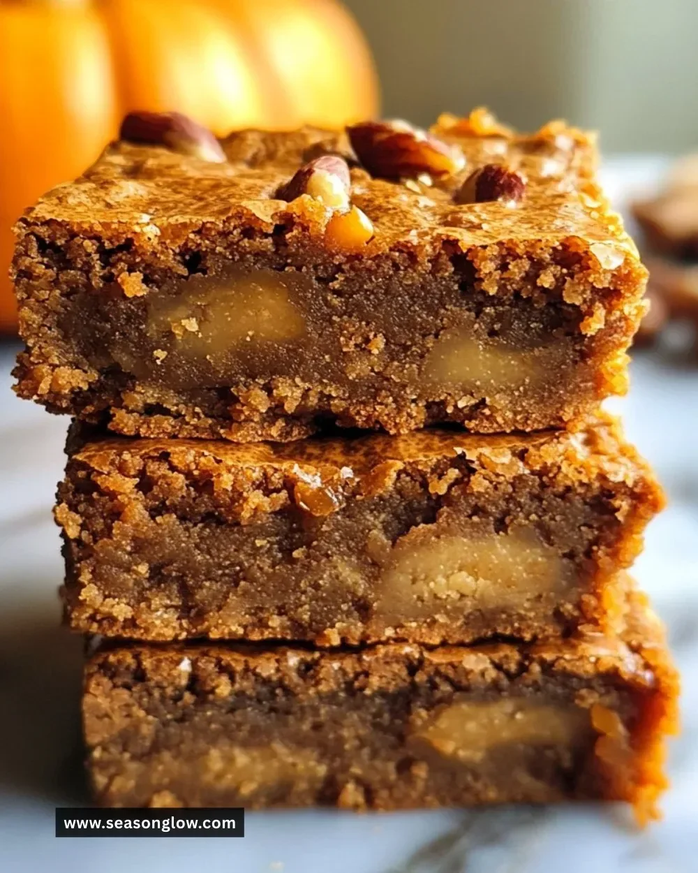 Delicious pumpkin maple blondies served on a wooden platter with autumn decor.