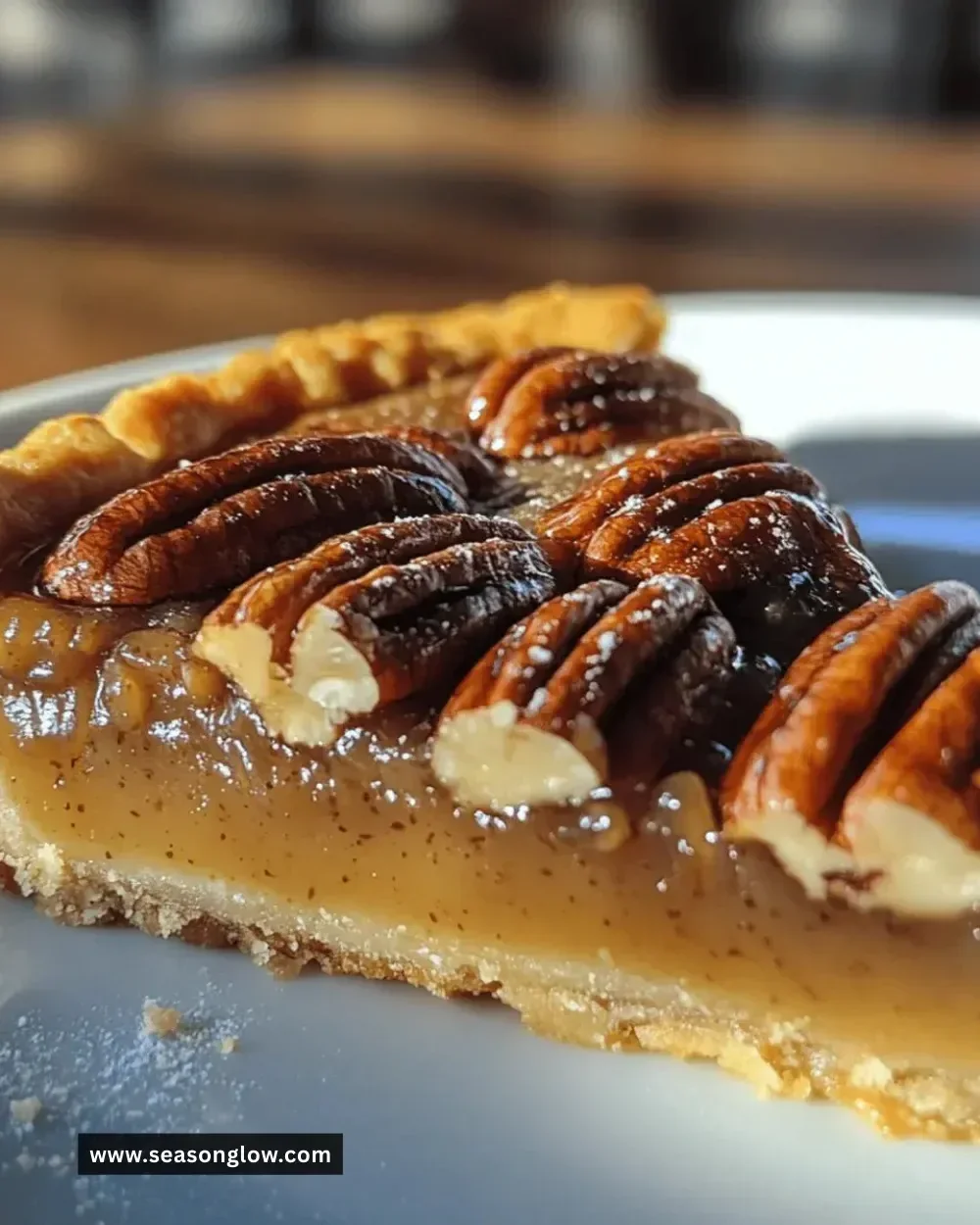 Delicious homemade salted caramel pecan tart topped with chocolate drizzle
