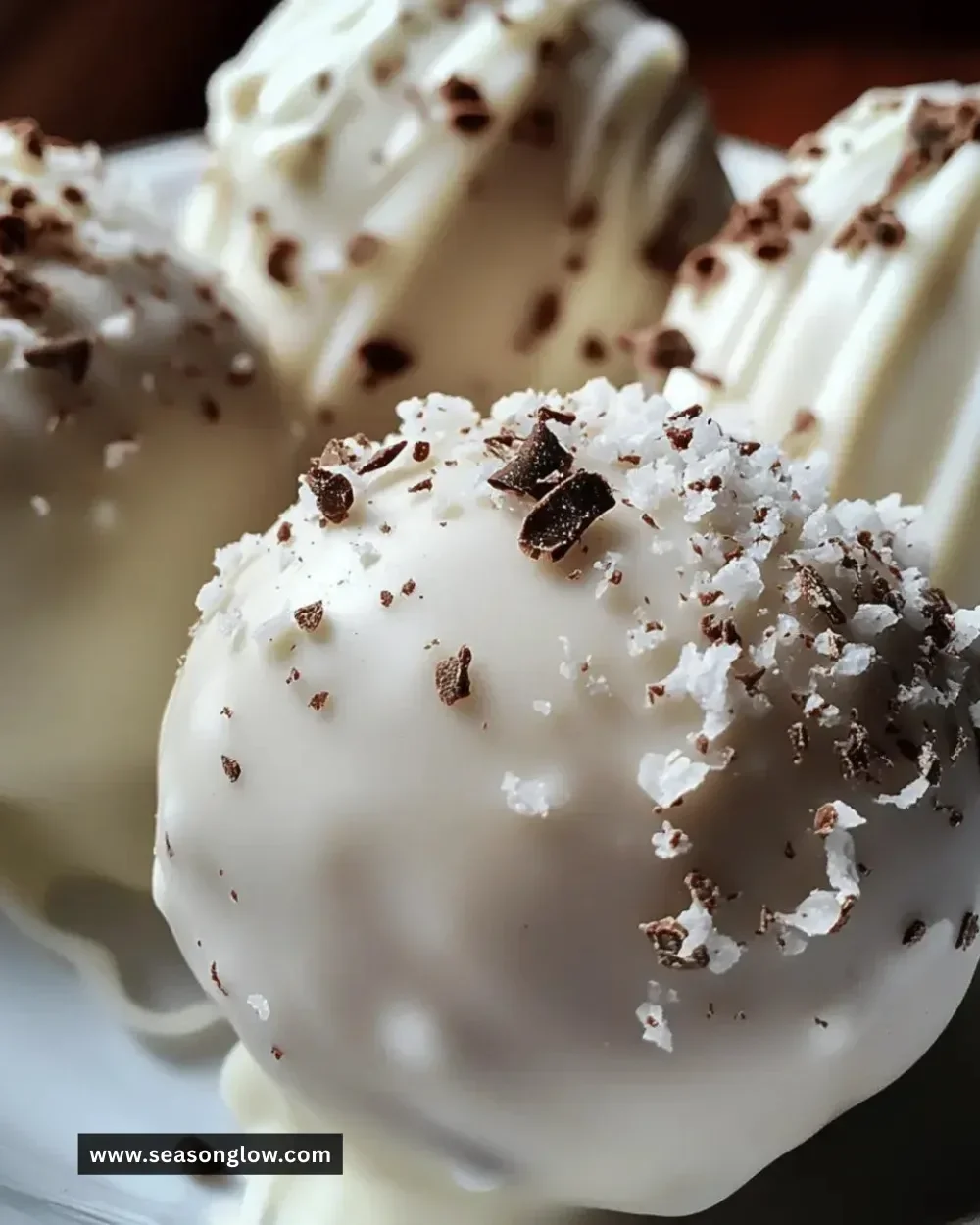 Deliciously crafted white chocolate truffle balls on a decorative plate.