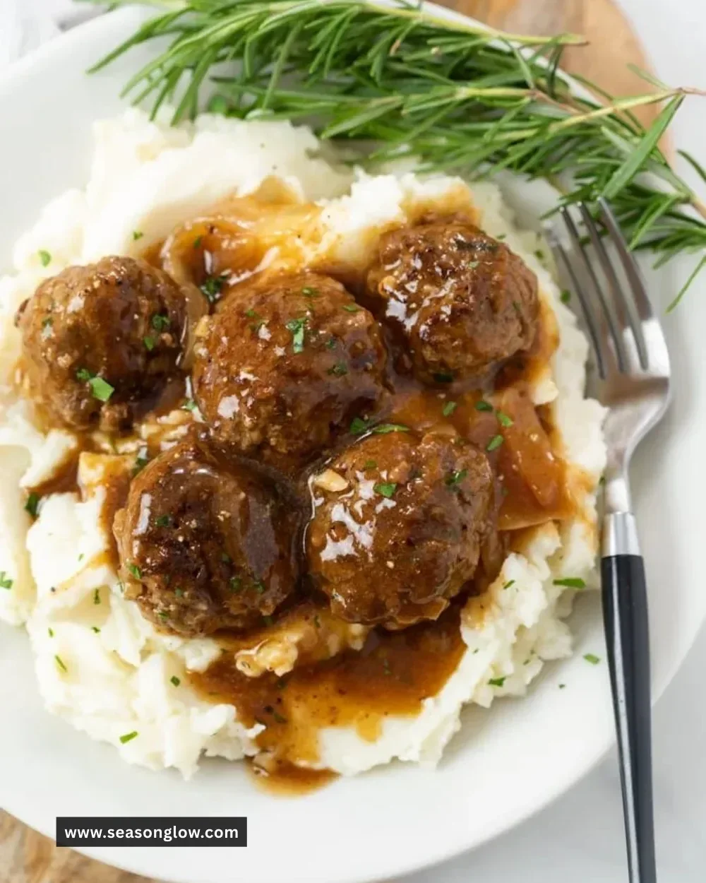 Juicy meatballs served with rich gravy on a plate