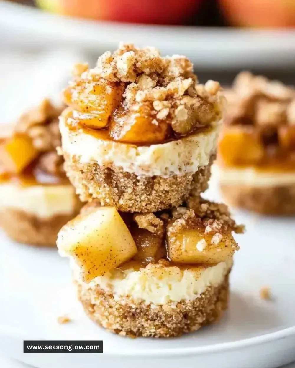 Mini apple pie cheesecake bites topped with caramel and cinnamon