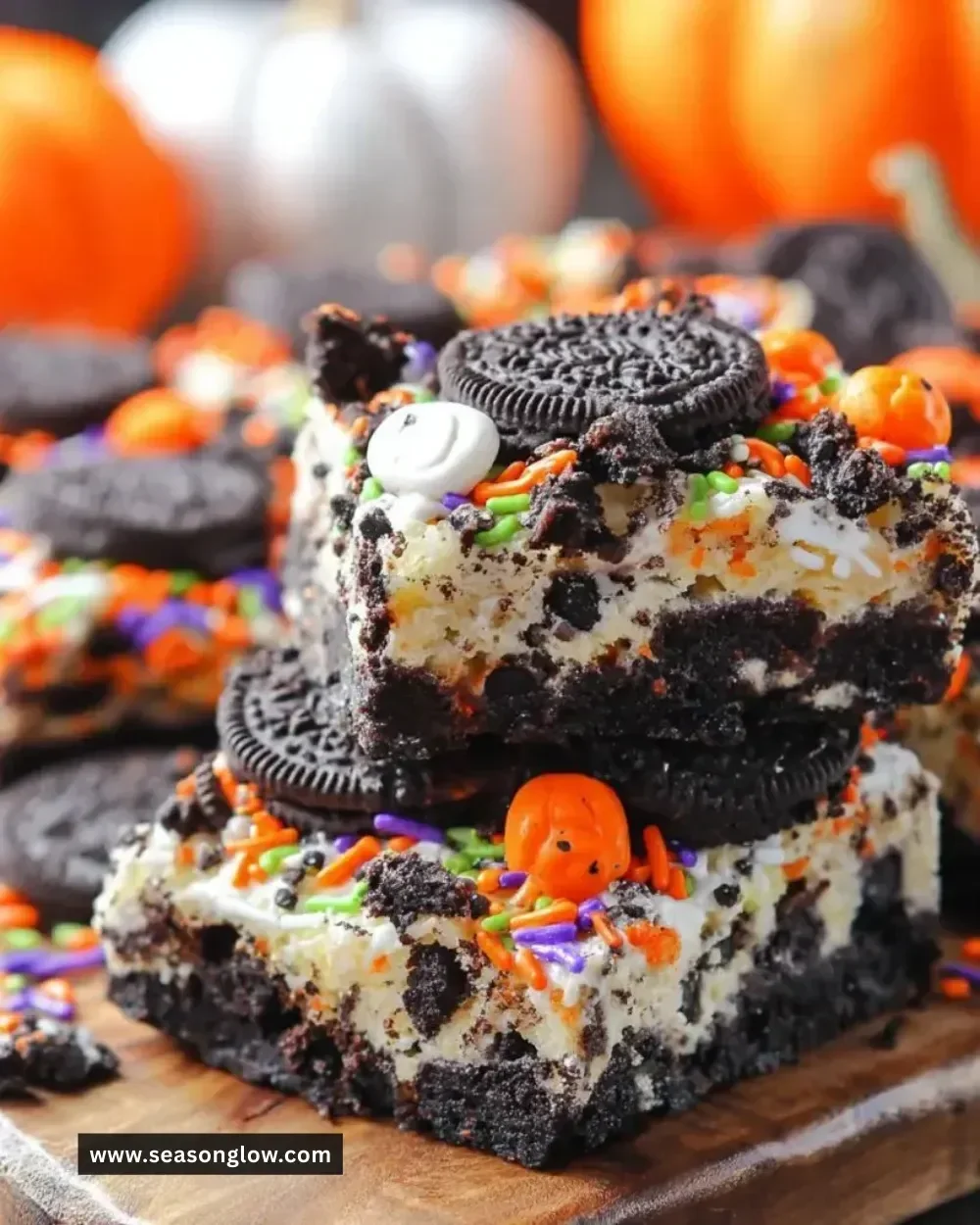 Decadent Oreo Cake Bars topped with crushed Oreos and chocolate drizzle