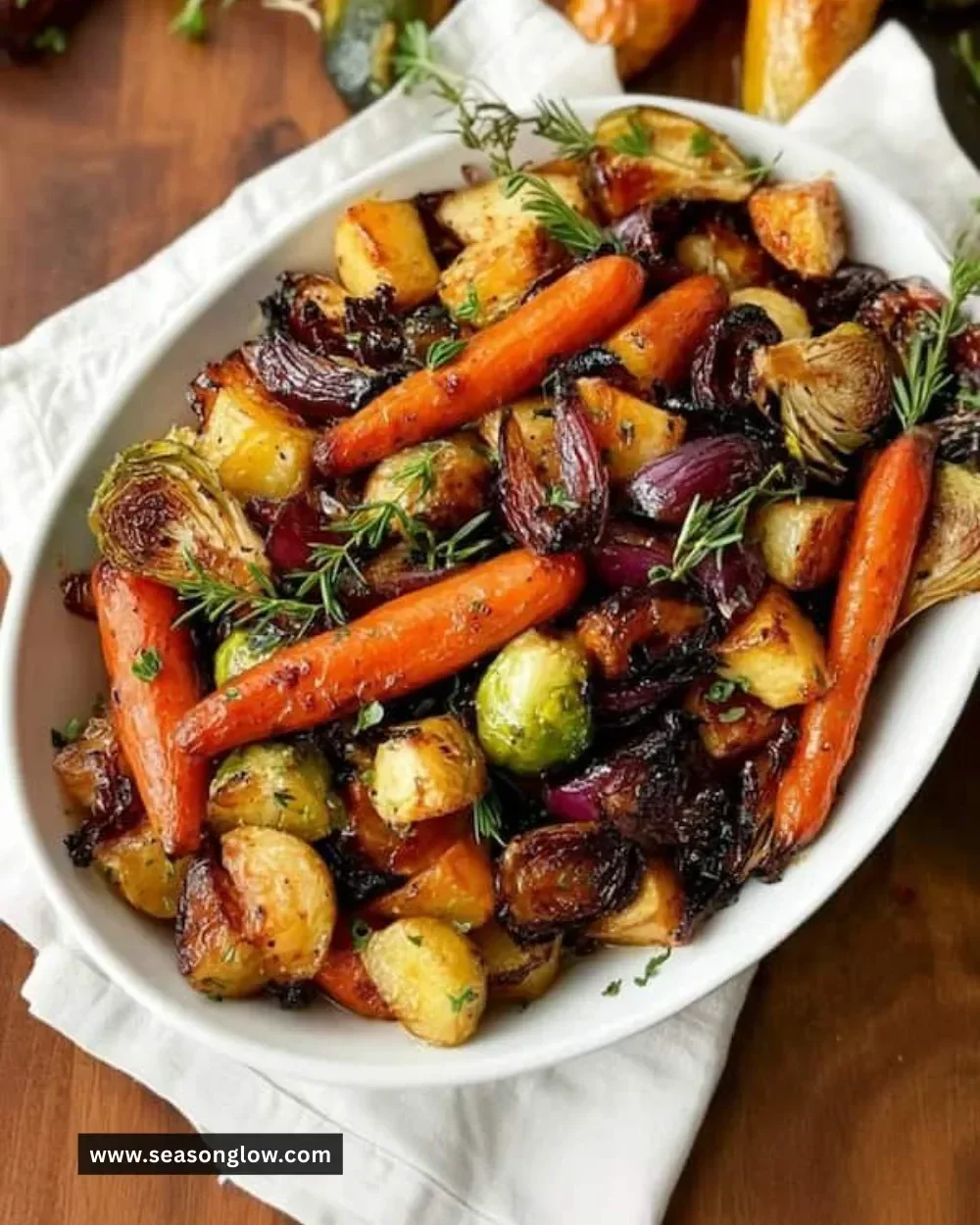 Colorful blend of oven roasted vegetables including carrots, bell peppers, and zucchini.
